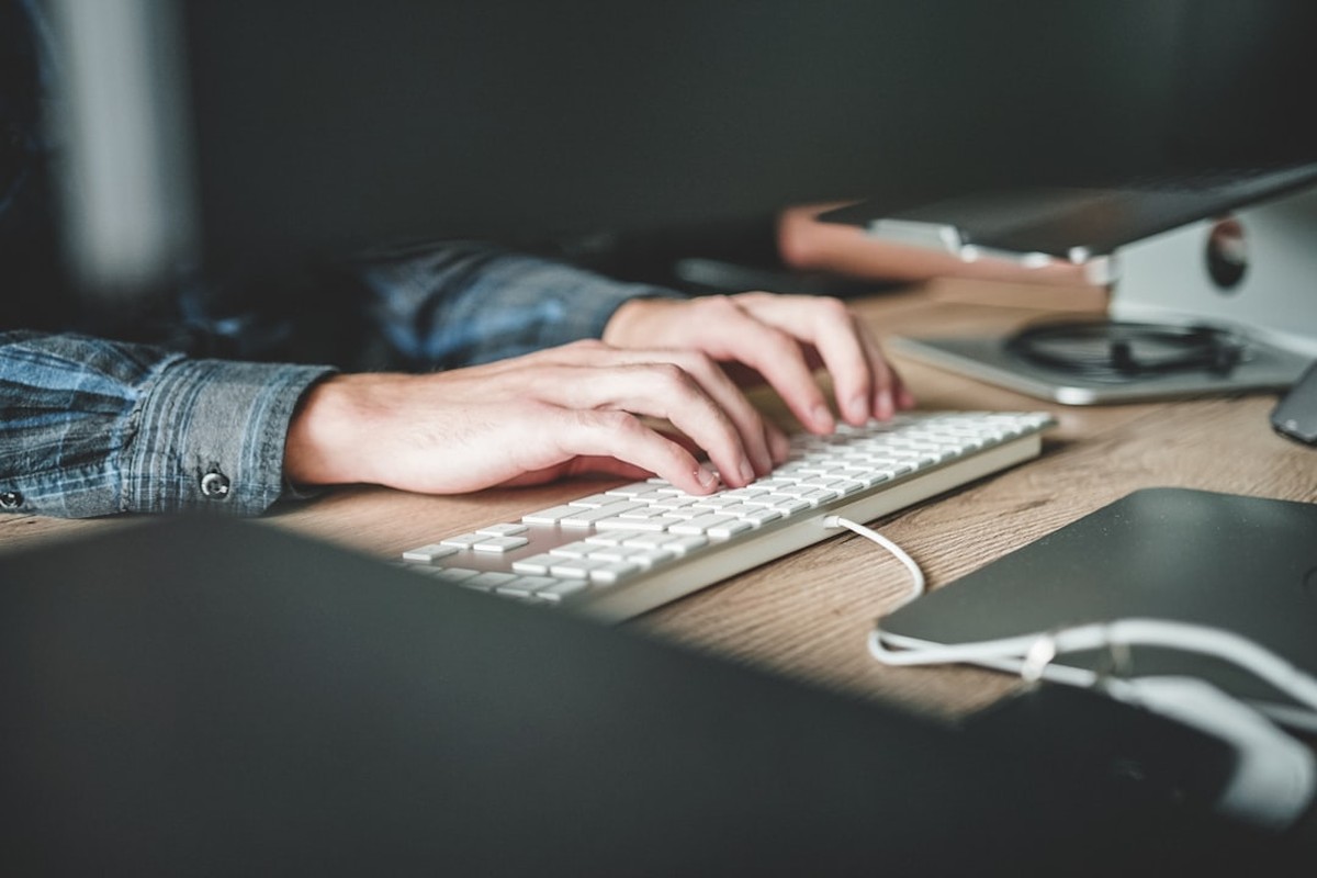people sitting on chair in front of computer monitor