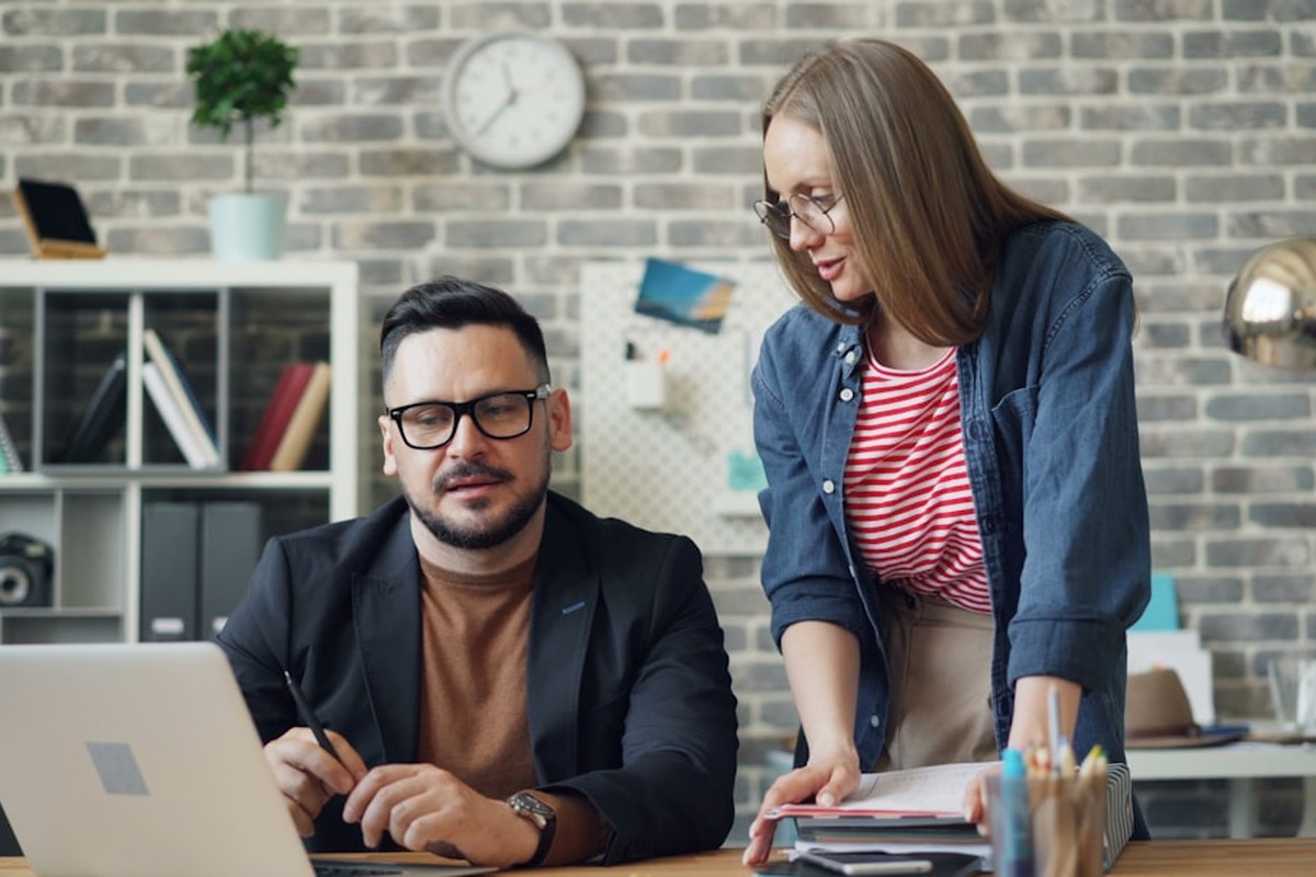 people sitting on chair in front of computer monitor