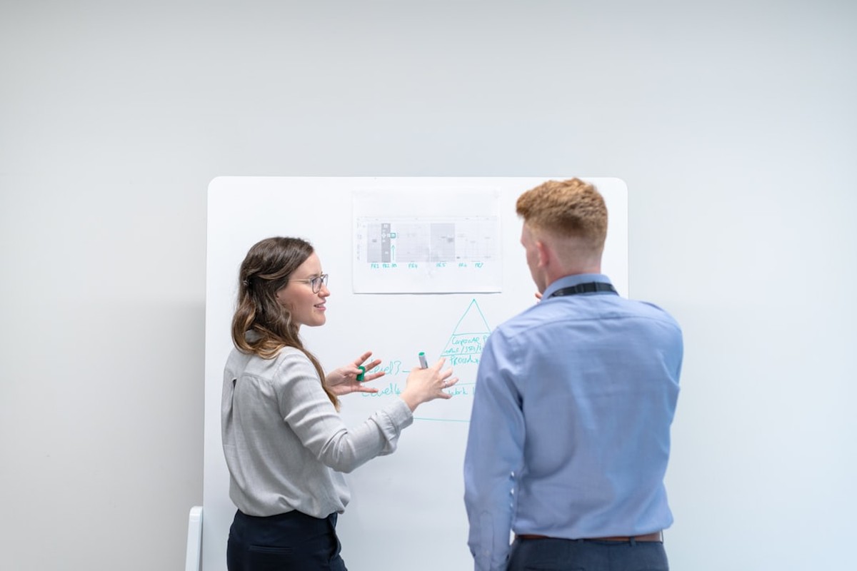 people sitting on chair in front of computer monitor